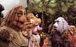 The three members of the grog family engaged in dialogue in the forest