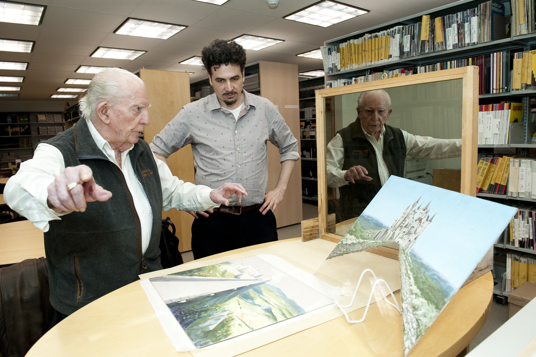 Pictured is Hackborn visiting the Ryerson Library and Archives on March 7, 2013 with archivist Curtis Sassur. Hackborn explains the technique behind the matte glass. (Photograph by Dave Upham, University photographer)