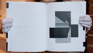 Two page spread of a photo book, black and white abstract photo on right hand page.