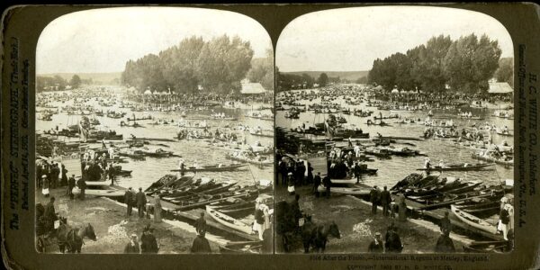 Henley Regatta in England. View of river with boats and people gathered on the shoreline