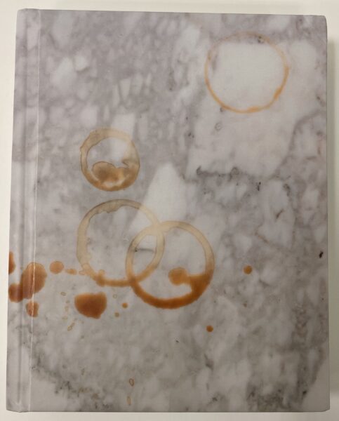 Grey marble book cover with stains from cups