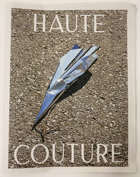 Newsprint with an image of a metal paper airplane and the text HAUTE COUTURE
