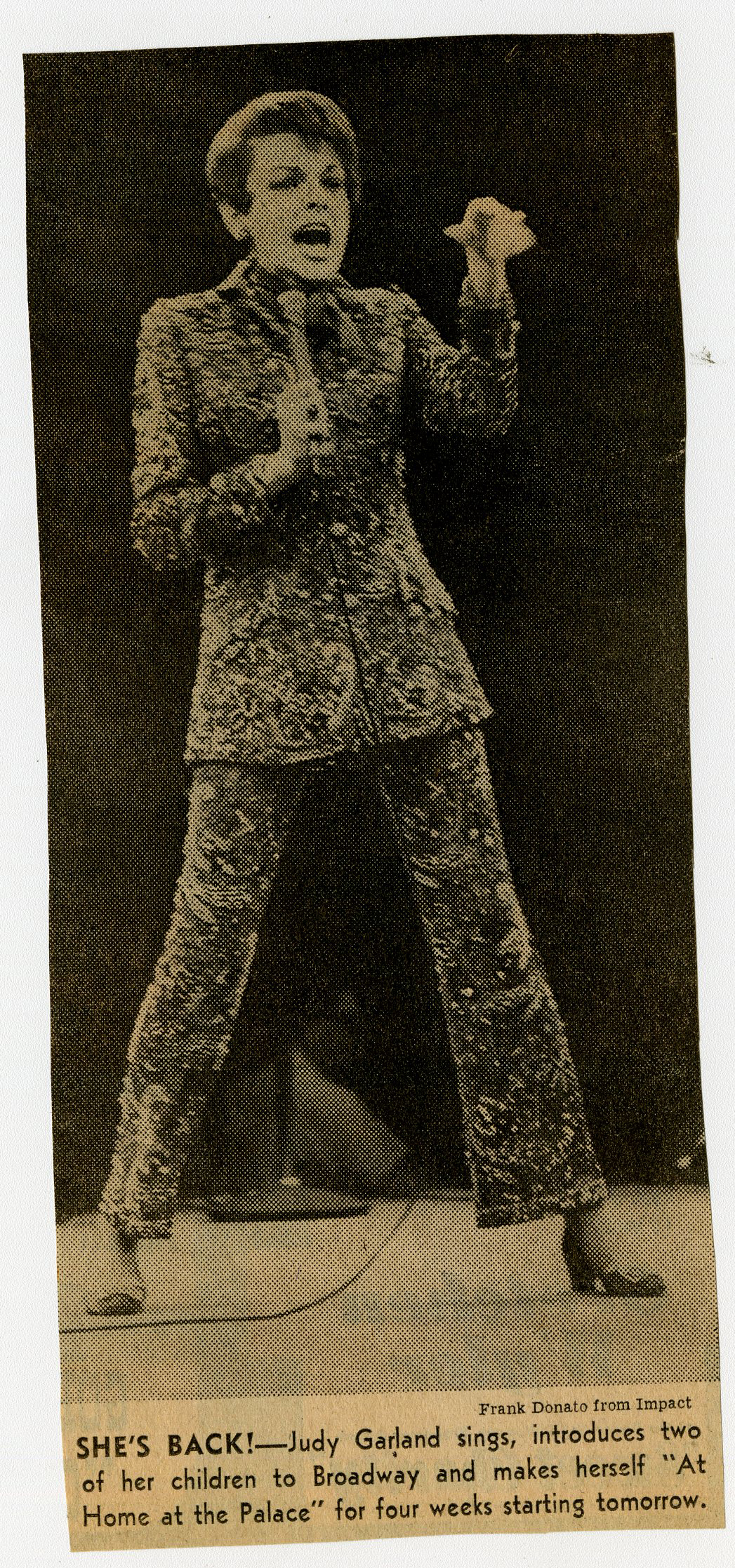 A newspaper clipping of Judy Garland, singing and wearing a suit.