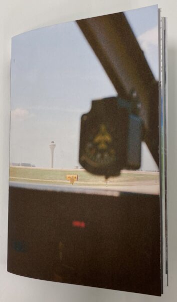Book cover with an image taken inside the front of an airplane