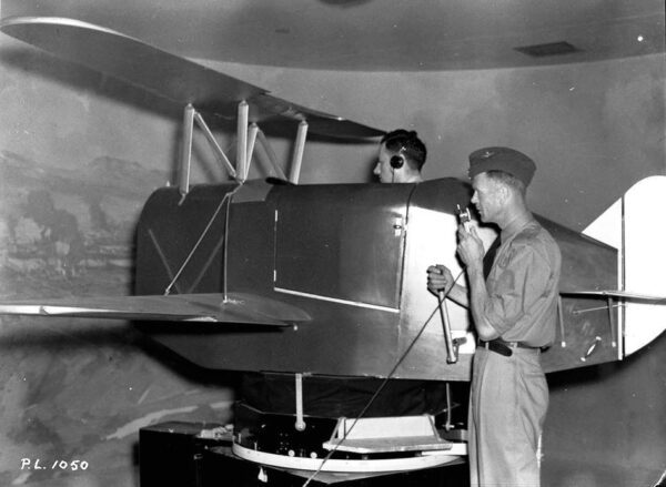 Recruit takes flight instructions from Flying Officer A.E. Jarvis, 25 July 1940, No. 1 ITS. (Library and Archives Canada Photo, MIKAN No. 4327232), image