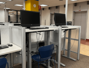 Two computer workstations with adjustable table tops