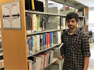 student staff holding book